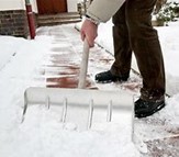 Snow being cleared off a footpath